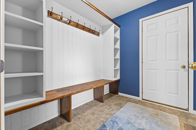 18358 Jenkins St NE, East Bethel, MN 55011 - mudroom with baseboards, a textured ceiling, tile patterned floors, and built in features