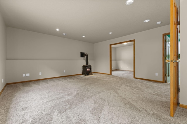 18358 Jenkins St NE, East Bethel, MN 55011 - unfurnished room with a wood stove, carpet floors, baseboards, and recessed lighting