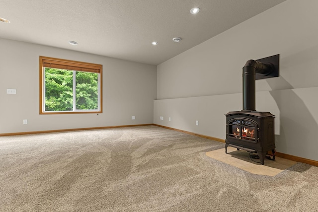 18358 Jenkins St NE, East Bethel, MN 55011 - unfurnished living room featuring carpet flooring, a wood stove, baseboards, recessed lighting, and a textured ceiling