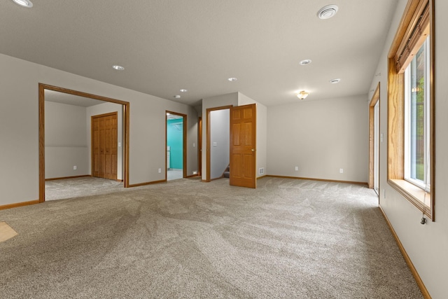 18358 Jenkins St NE, East Bethel, MN 55011 - unfurnished room with light carpet, plenty of natural light, baseboards, and recessed lighting