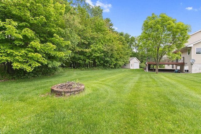 18358 Jenkins St NE, East Bethel, MN 55011 - view of grassy yard featuring a fire pit and a deck