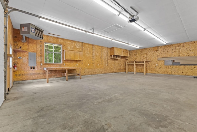 18358 Jenkins St NE, East Bethel, MN 55011 - garage with a garage door opener, a heating unit, electric panel, and a workshop area