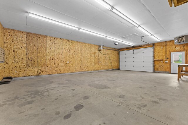 18358 Jenkins St NE, East Bethel, MN 55011 - garage featuring wood walls and a garage door opener