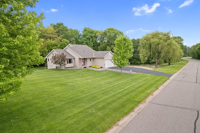 18358 Jenkins St NE, East Bethel, MN 55011 - view of front facade featuring driveway, a front lawn, and an attached garage