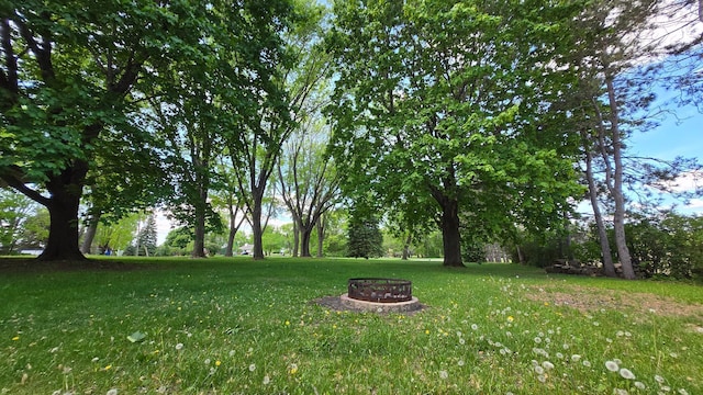 8170 113th St S, Cottage Grove, MN 55016 - view of green lawn with an outdoor fire pit