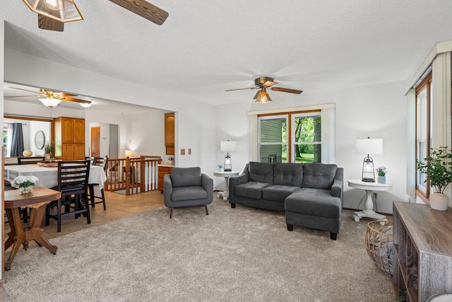 8170 113th St S, Cottage Grove, MN 55016 - living room with ceiling fan, a textured ceiling, light carpet, and light tile patterned flooring