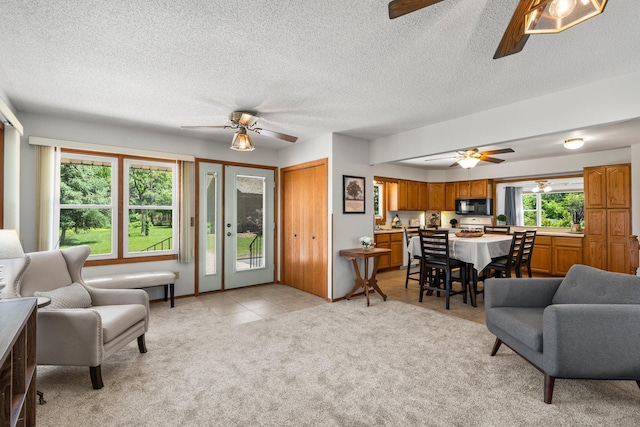8170 113th St S, Cottage Grove, MN 55016 - living room featuring ceiling fan, light carpet, light tile patterned floors, and a textured ceiling