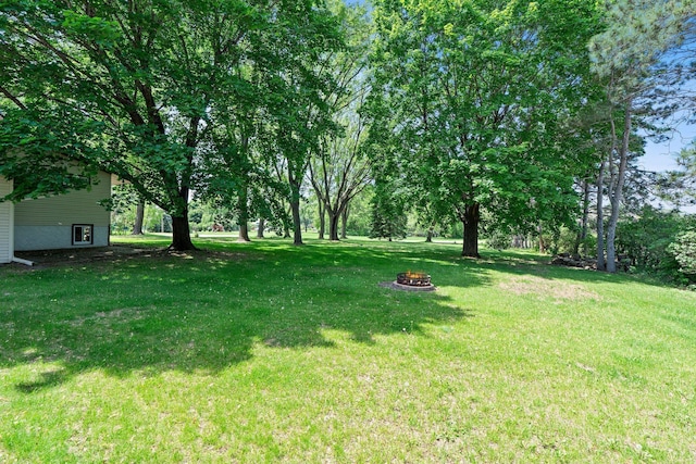 8170 113th St S, Cottage Grove, MN 55016 - view of grassy yard with an outdoor fire pit