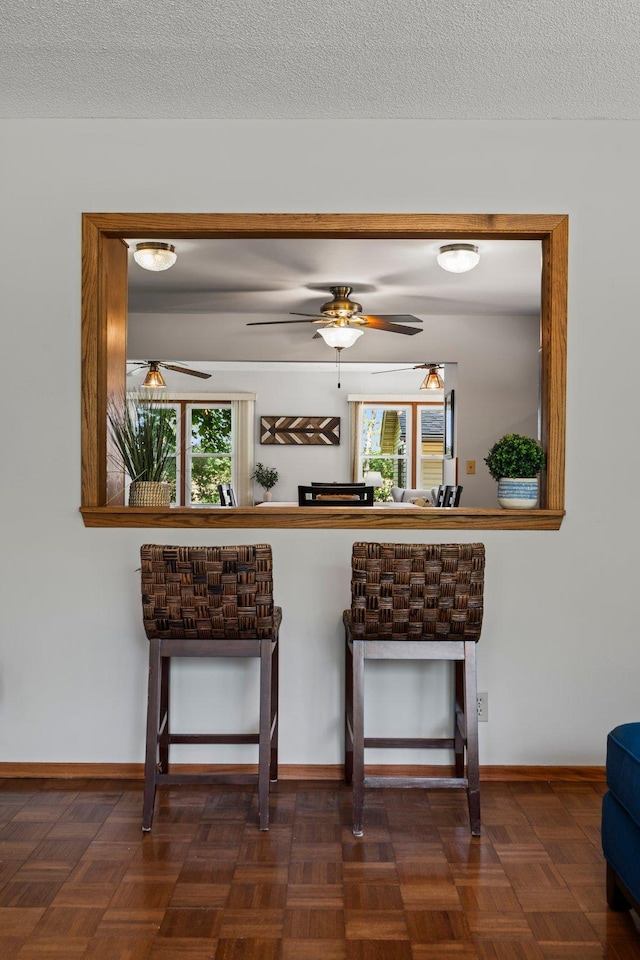 8170 113th St S, Cottage Grove, MN 55016 - kitchen with ceiling fan, baseboards, and a breakfast bar area