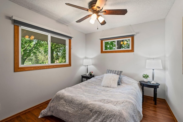 8170 113th St S, Cottage Grove, MN 55016 - bedroom featuring wood finished floors, baseboards, a textured ceiling, and ceiling fan