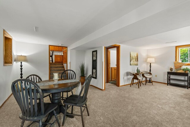 8170 113th St S, Cottage Grove, MN 55016 - dining area featuring light colored carpet, stairway, and baseboards