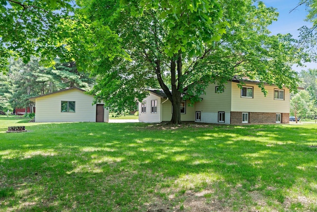8170 113th St S, Cottage Grove, MN 55016 - view of green lawn featuring an outdoor fire pit
