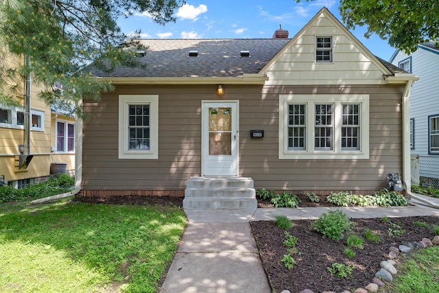 5749 Pleasant Ave S, Minneapolis, MN 55419 - bungalow-style house with roof with shingles, a front lawn, entry steps, and a chimney