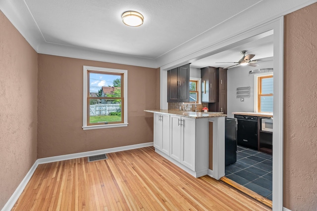 5749 Pleasant Ave S, Minneapolis, MN 55419 - kitchen featuring a textured wall, light wood-type flooring, baseboards, ceiling fan, and stainless steel microwave