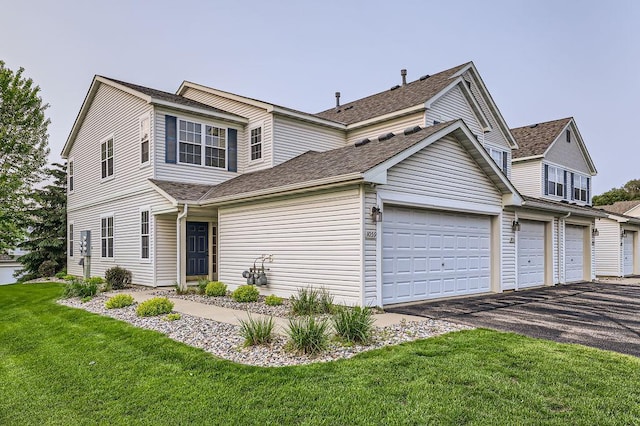 1059 Providence Dr, Shakopee, MN 55379 - traditional-style house featuring asphalt driveway, a front lawn, and a shingled roof