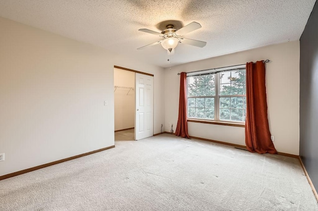 1059 Providence Dr, Shakopee, MN 55379 - unfurnished bedroom featuring light carpet, a closet, baseboards, a textured ceiling, and ceiling fan