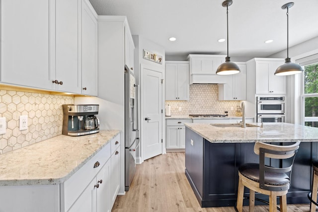 7137 61st St S, Cottage Grove, MN 55016 - kitchen featuring a sink, appliances with stainless steel finishes, backsplash, light wood-type flooring, and recessed lighting