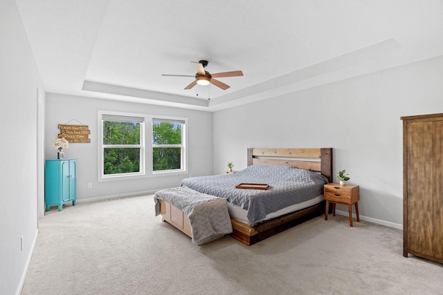 7137 61st St S, Cottage Grove, MN 55016 - carpeted bedroom featuring a tray ceiling, baseboards, and a ceiling fan