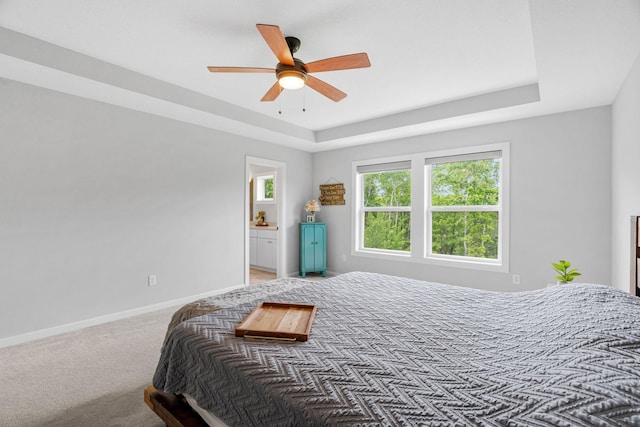 7137 61st St S, Cottage Grove, MN 55016 - bedroom with baseboards, a raised ceiling, ceiling fan, light colored carpet, and ensuite bathroom