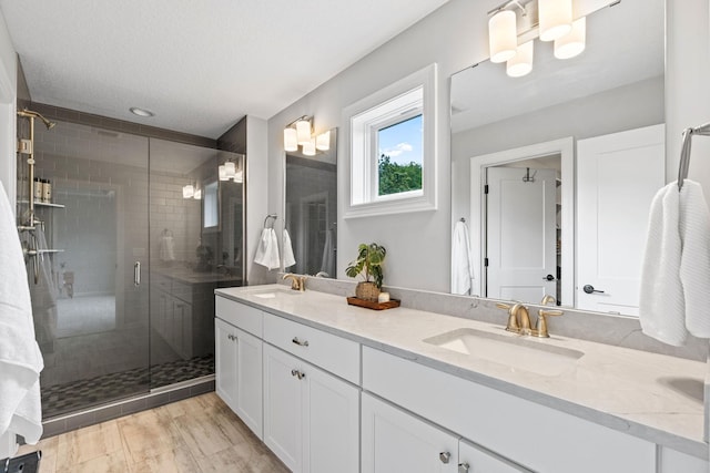 7137 61st St S, Cottage Grove, MN 55016 - bathroom featuring double vanity, a shower stall, and recessed lighting