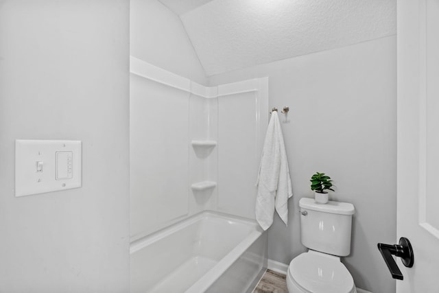 7137 61st St S, Cottage Grove, MN 55016 - full bath with vaulted ceiling, a textured ceiling, toilet, baseboards, and shower / bath combination