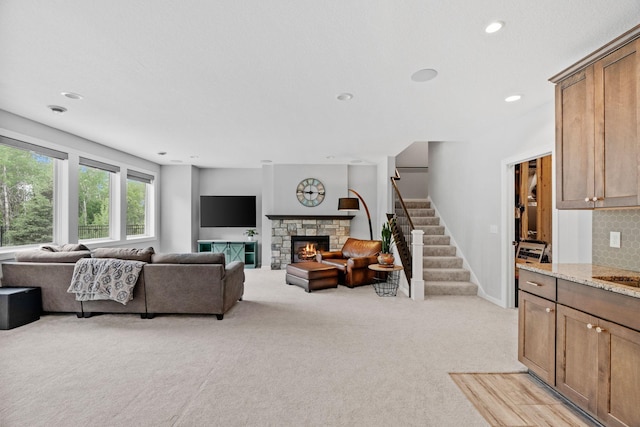 7137 61st St S, Cottage Grove, MN 55016 - living area featuring stairway, light colored carpet, a fireplace, recessed lighting, and baseboards
