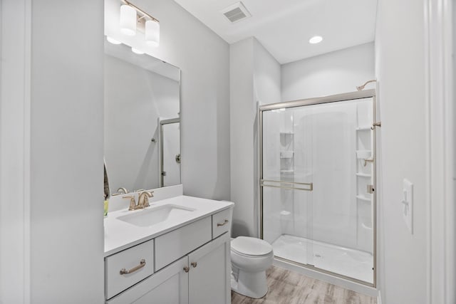 7137 61st St S, Cottage Grove, MN 55016 - bathroom featuring toilet, a stall shower, vanity, and wood finished floors