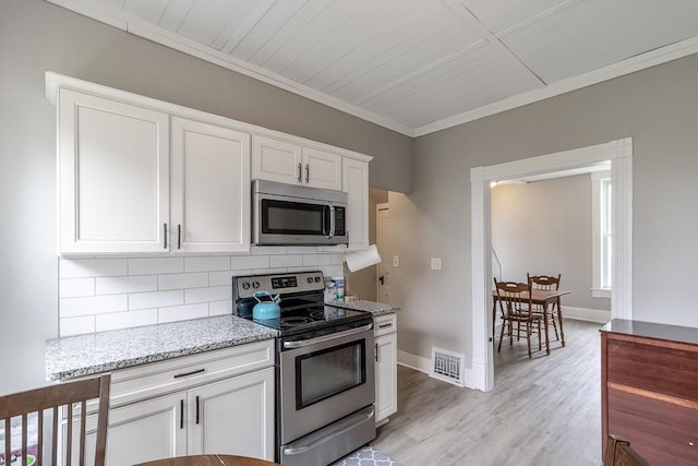 202 Adams St, Arlington, MN 55307 - kitchen with appliances with stainless steel finishes, ornamental molding, tasteful backsplash, white cabinets, and light stone countertops