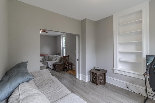 202 Adams St, Arlington, MN 55307 - living area featuring wood finished floors, baseboards, ceiling fan, and built in features