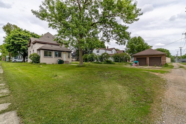 202 Adams St, Arlington, MN 55307 - view of grassy yard featuring a garage