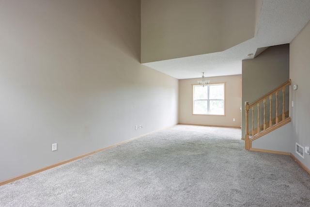 3003 Cutters Grove Ave, Anoka, MN 55303 - spare room featuring a chandelier, carpet, stairs, and baseboards