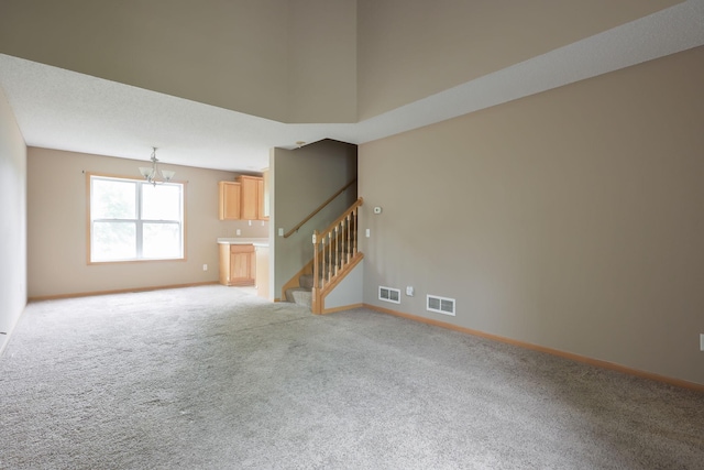 3003 Cutters Grove Ave, Anoka, MN 55303 - spare room featuring a chandelier, light carpet, stairway, and baseboards