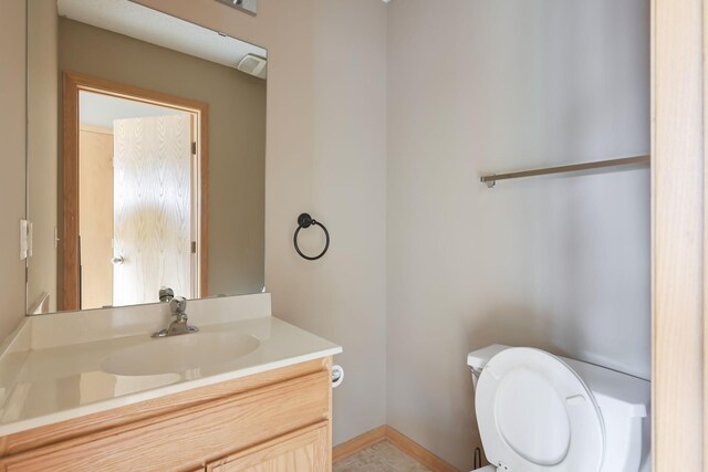 3003 Cutters Grove Ave, Anoka, MN 55303 - half bath featuring toilet, vanity, and baseboards