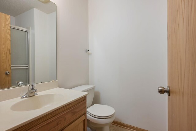 3003 Cutters Grove Ave, Anoka, MN 55303 - bathroom featuring toilet, vanity, and a shower with door