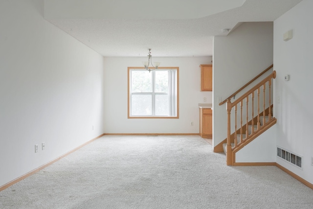 3007 Cutters Grove Ave, Anoka, MN 55303 - unfurnished living room with light carpet, a chandelier, stairs, and baseboards
