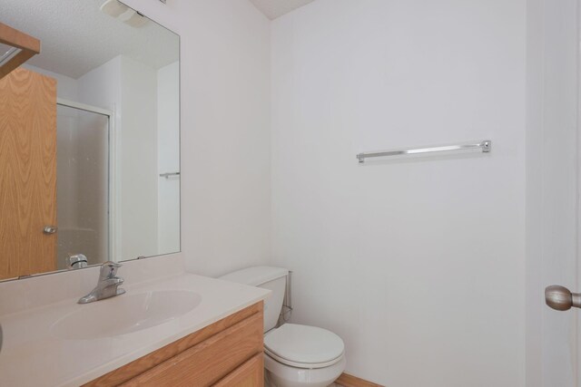 3007 Cutters Grove Ave, Anoka, MN 55303 - bathroom featuring vanity, toilet, and a stall shower