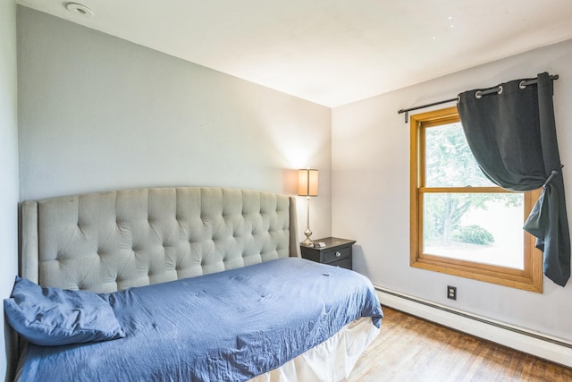 816 Glenbrook Ave N, Oakdale, MN 55128 - bedroom with baseboard heating, wood finished floors, and baseboards