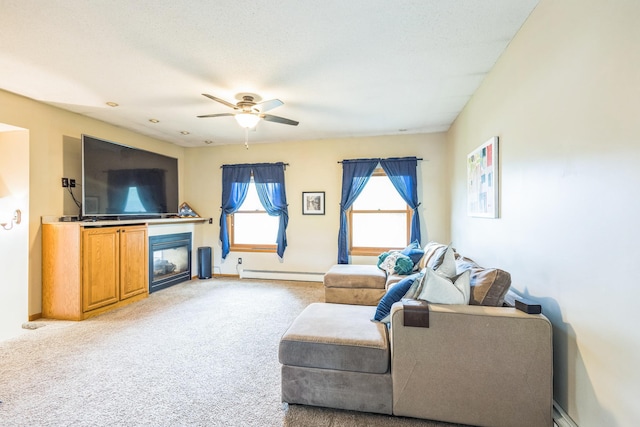 816 Glenbrook Ave N, Oakdale, MN 55128 - carpeted living area featuring a baseboard radiator, a ceiling fan, a glass covered fireplace, and baseboards