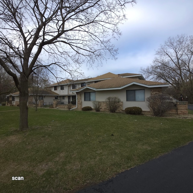 2649 Brookdale Ln, Brooklyn Park, MN 55444 - view of front facade featuring a front lawn and roof with shingles