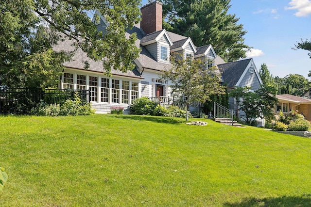 14 Forest Dale Rd, Minneapolis, MN 55410 - rear view of property with a lawn, a shingled roof, and a chimney