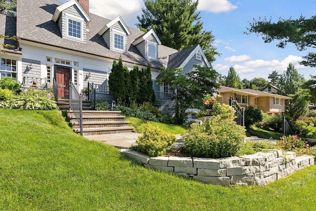 14 Forest Dale Rd, Minneapolis, MN 55410 - view of front facade featuring a front lawn, a chimney, and a shingled roof