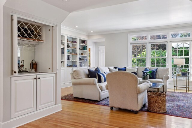 14 Forest Dale Rd, Minneapolis, MN 55410 - living area featuring light wood finished floors, ornamental molding, a bar, recessed lighting, and built in shelves