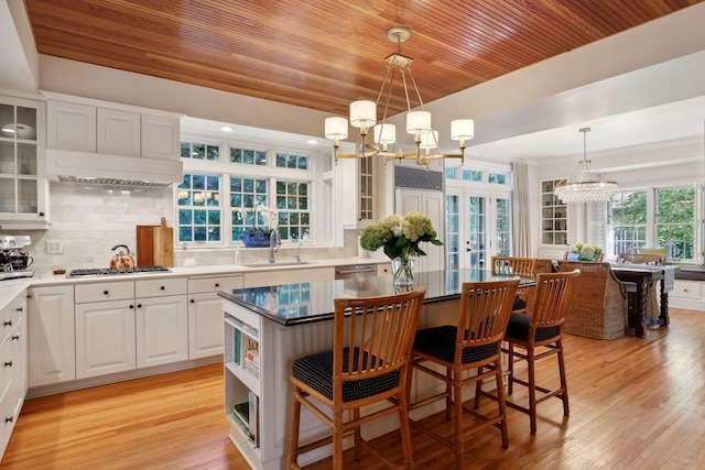 14 Forest Dale Rd, Minneapolis, MN 55410 - kitchen with a chandelier, wood ceiling, french doors, gas cooktop, and a breakfast bar