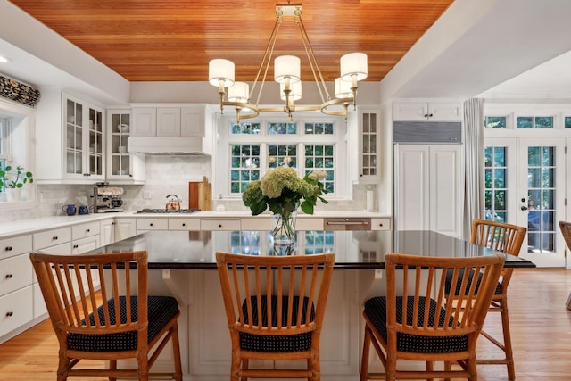 14 Forest Dale Rd, Minneapolis, MN 55410 - kitchen featuring a chandelier, wooden ceiling, white cabinetry, gas cooktop, and tasteful backsplash