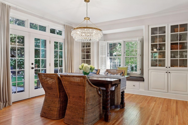 14 Forest Dale Rd, Minneapolis, MN 55410 - dining area featuring a chandelier, crown molding, light wood-type flooring, and french doors