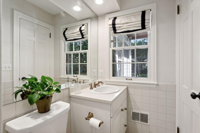 14 Forest Dale Rd, Minneapolis, MN 55410 - half bathroom featuring tile walls, vanity, and toilet