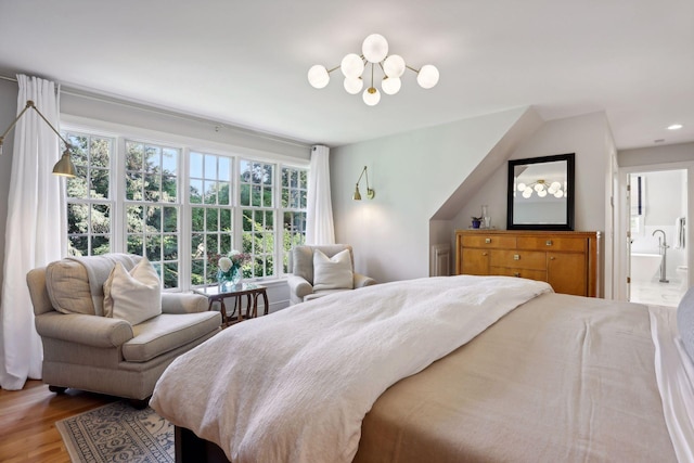 14 Forest Dale Rd, Minneapolis, MN 55410 - bedroom featuring a chandelier, wood finished floors, recessed lighting, and connected bathroom