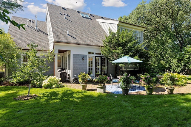 14 Forest Dale Rd, Minneapolis, MN 55410 - rear view of property featuring a shingled roof, a patio area, and a lawn