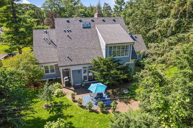 14 Forest Dale Rd, Minneapolis, MN 55410 - back of house featuring a patio, a shingled roof, and a chimney