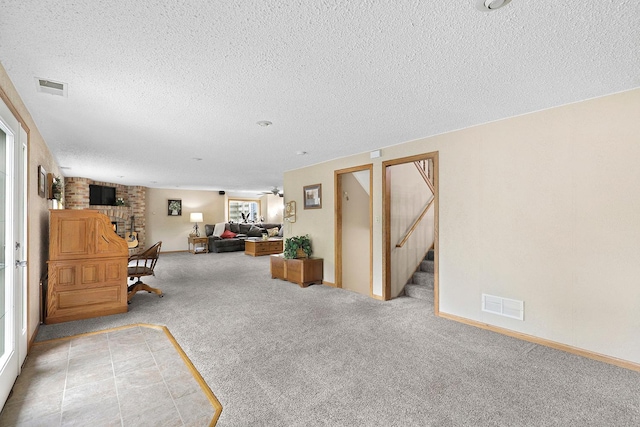 843 Northdale Blvd NW, Coon Rapids, MN 55448 - living area with carpet, a textured ceiling, a fireplace, and baseboards